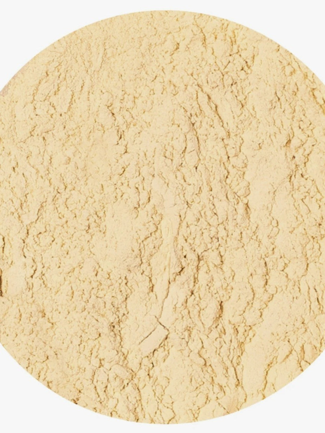 A close-up circular view of a light beige textured powder on a white background.