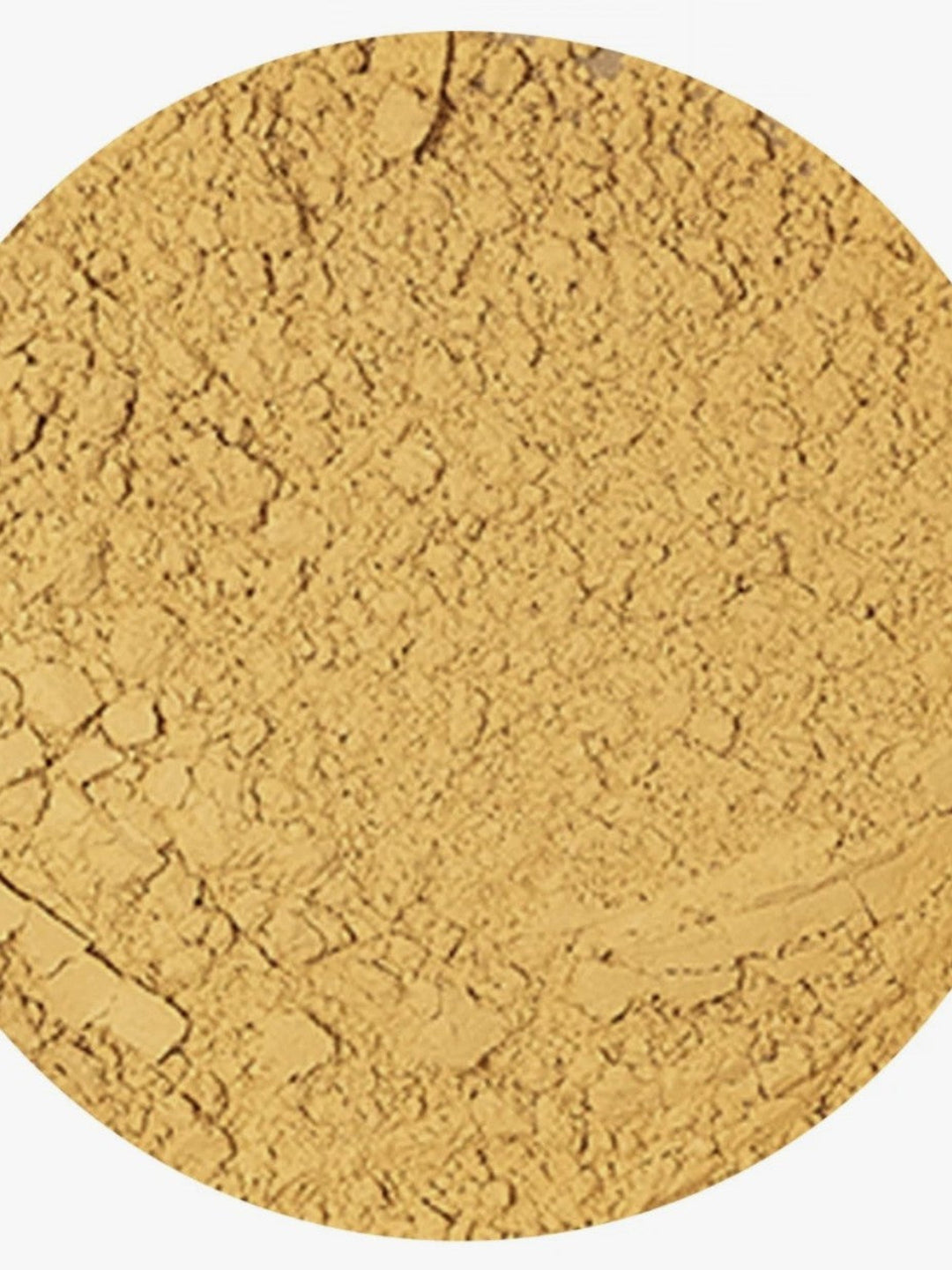A close-up circular view of a fine, textured golden-yellow powder, likely cosmetic powder or pigment, on a white background.