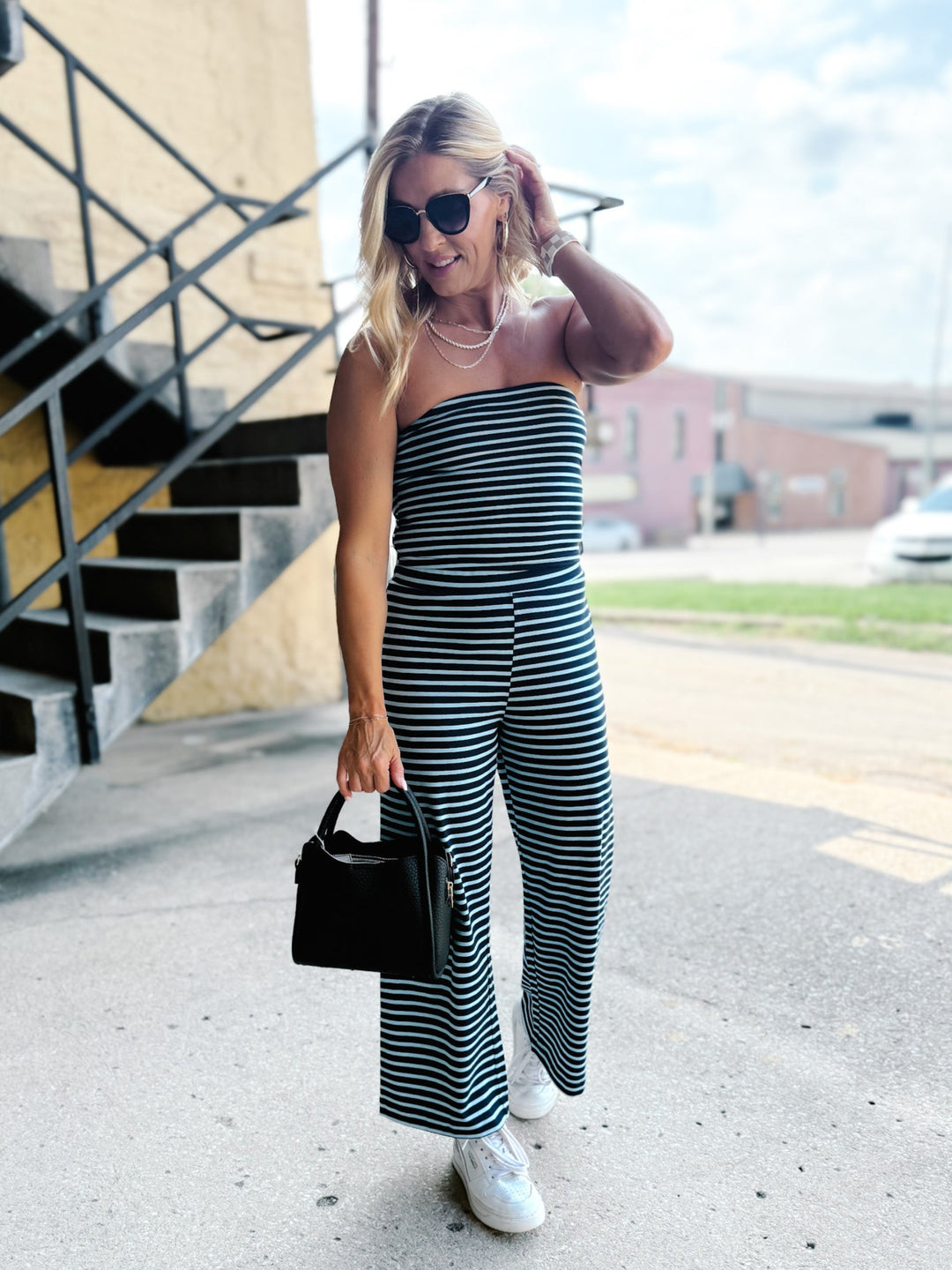 Model wearing the Boardwalk Strapless Stripe 2pc Set in navy and sky