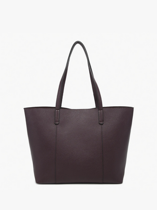 A dark plum pebbled leather tote bag with two shoulder straps, shown against a plain white background.