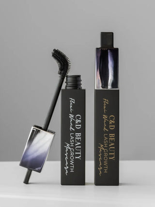 C&D Beauty Fine Wire Lash Growth Serum in a black rectangular tube with gold lettering, shown alongside its applicator wand and cap on a light gray background.