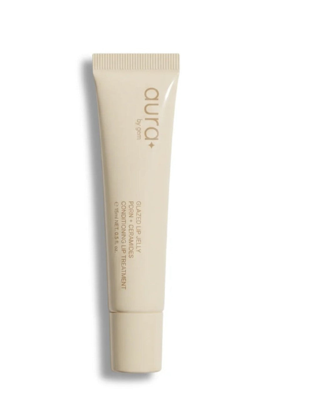 A beige cosmetic tube with a matching cap, featuring the brand name &