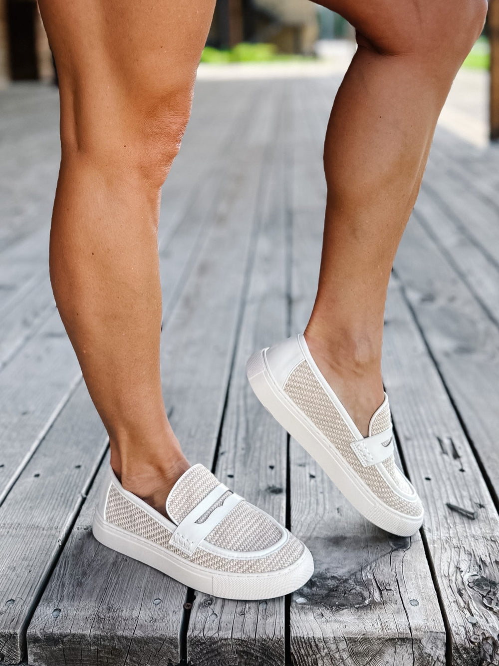 White combo slip-on loafers with breathable woven upper and leather accents.