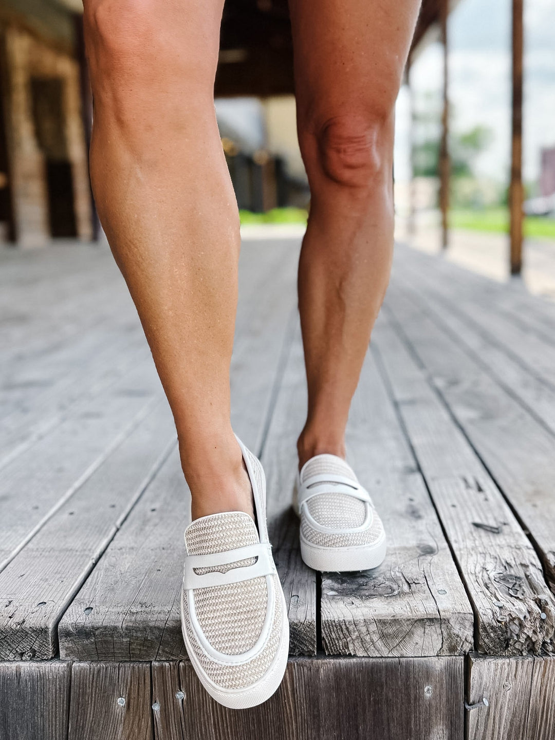 White combo slip-on loafers with breathable woven upper and leather accents.