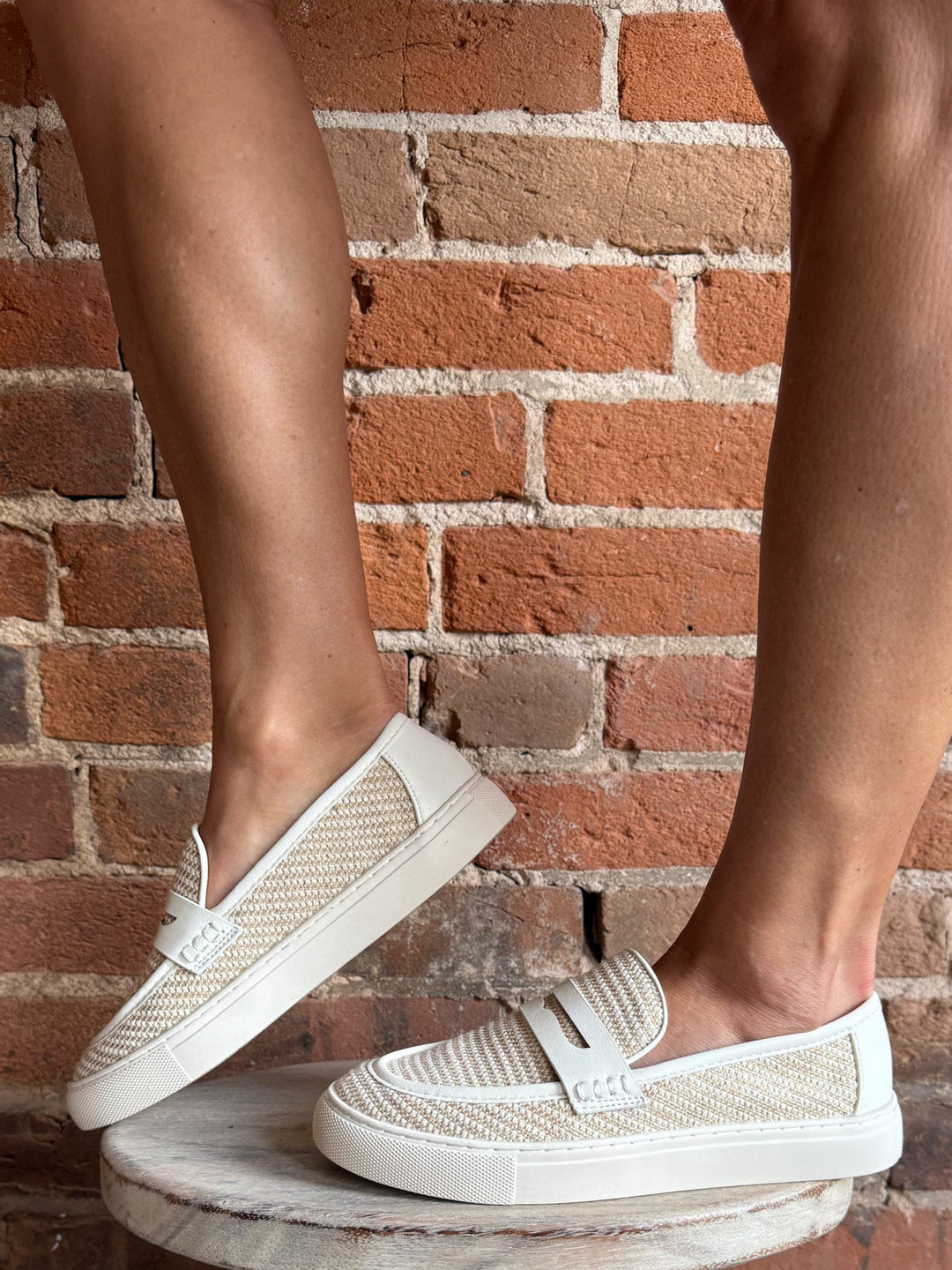 White combo slip-on loafers with breathable woven upper and leather accents.