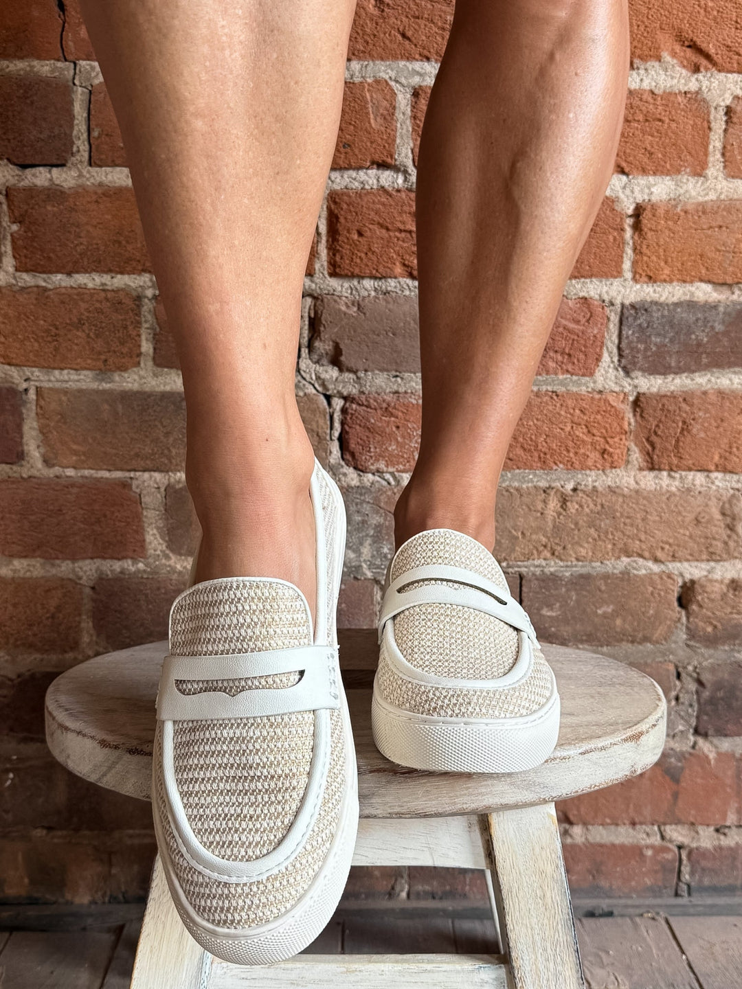 White combo slip-on loafers with breathable woven upper and leather accents.