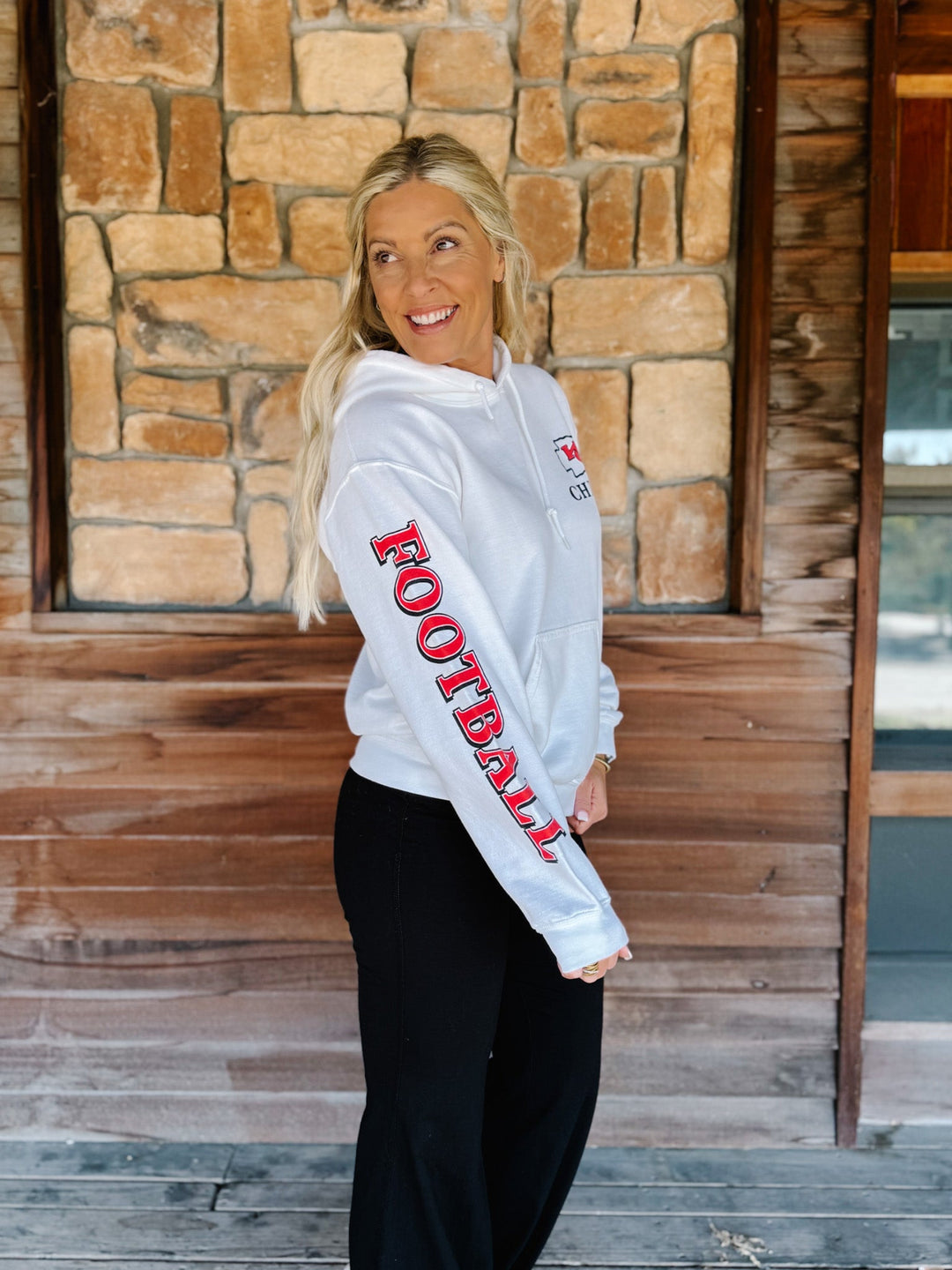 A woman wearing a white hoodie with &