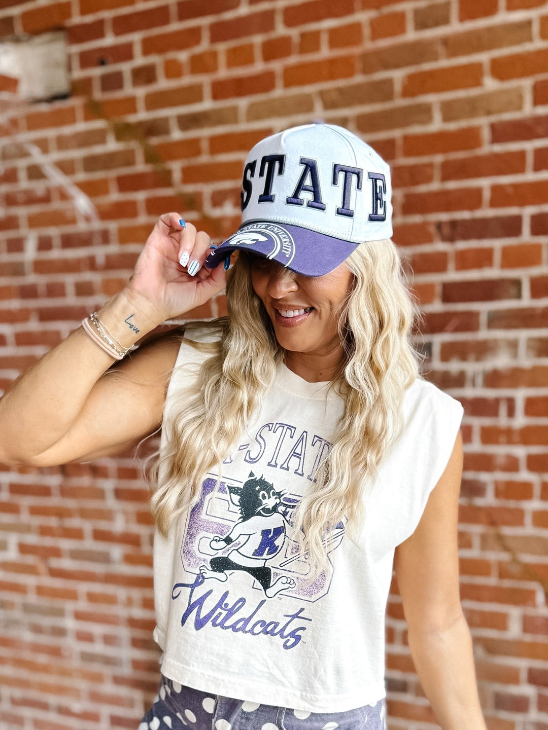 A woman wearing a white and purple &