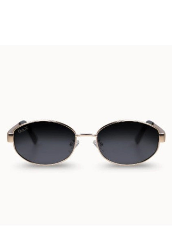 Dior oval sunglasses with dark gray lenses and a gold metal frame, shown against a plain white background.