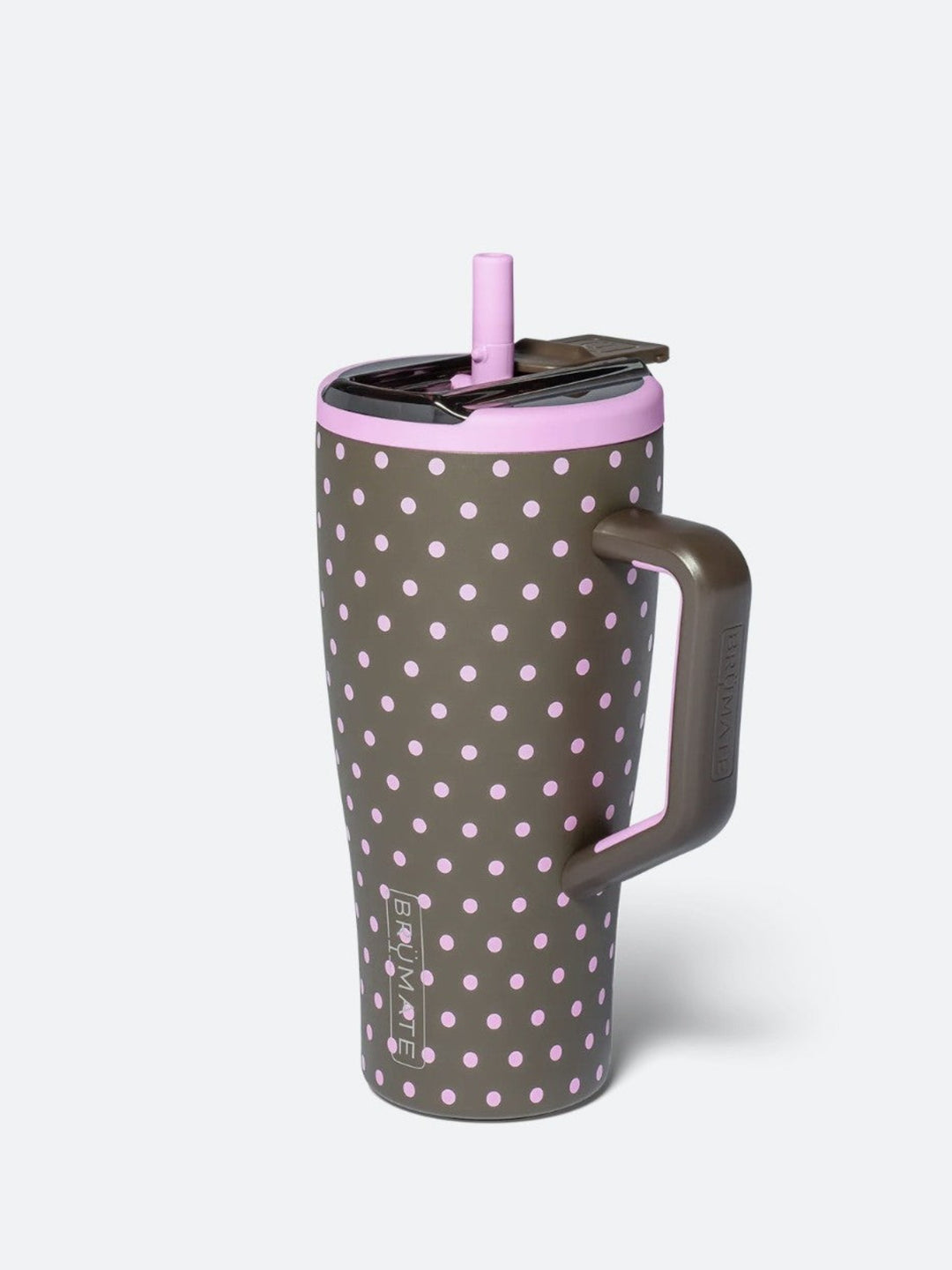 A tall insulated travel tumbler with a handle, featuring a dark gray body with a light pink polka dot pattern, a matching pink lid, and a pink straw, shown on a light gray background.