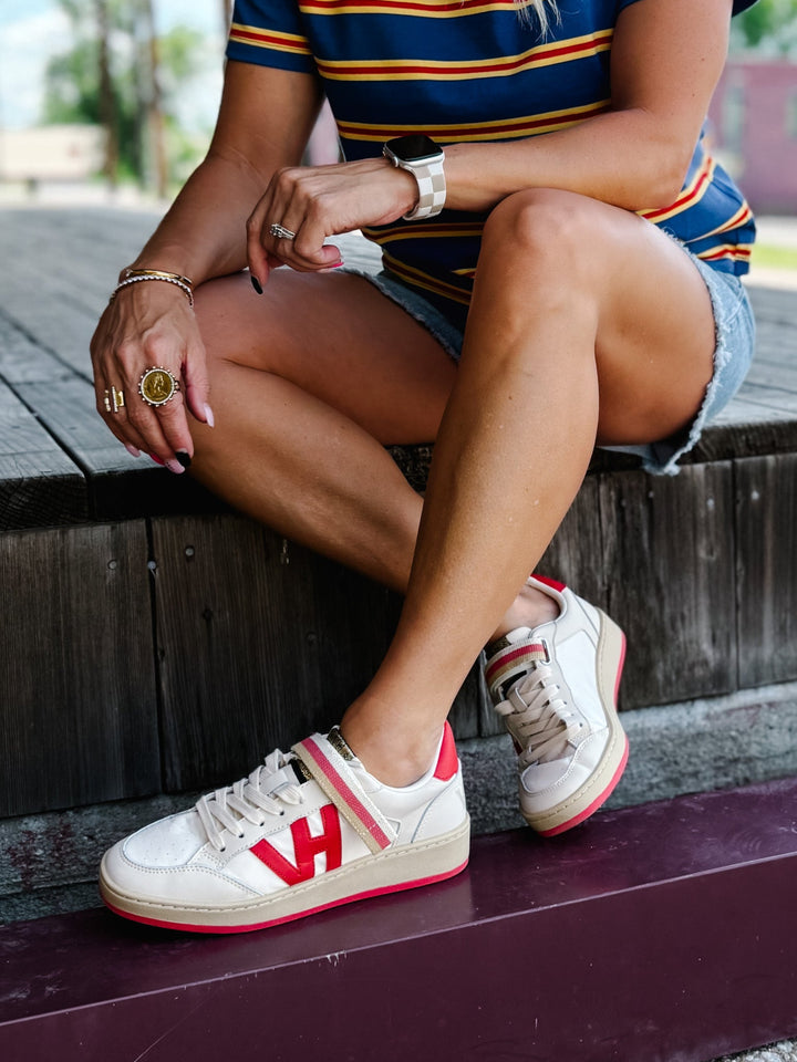 Vintage Havana Next 1 Sneaker with red accents, striped strap, and VH logo.