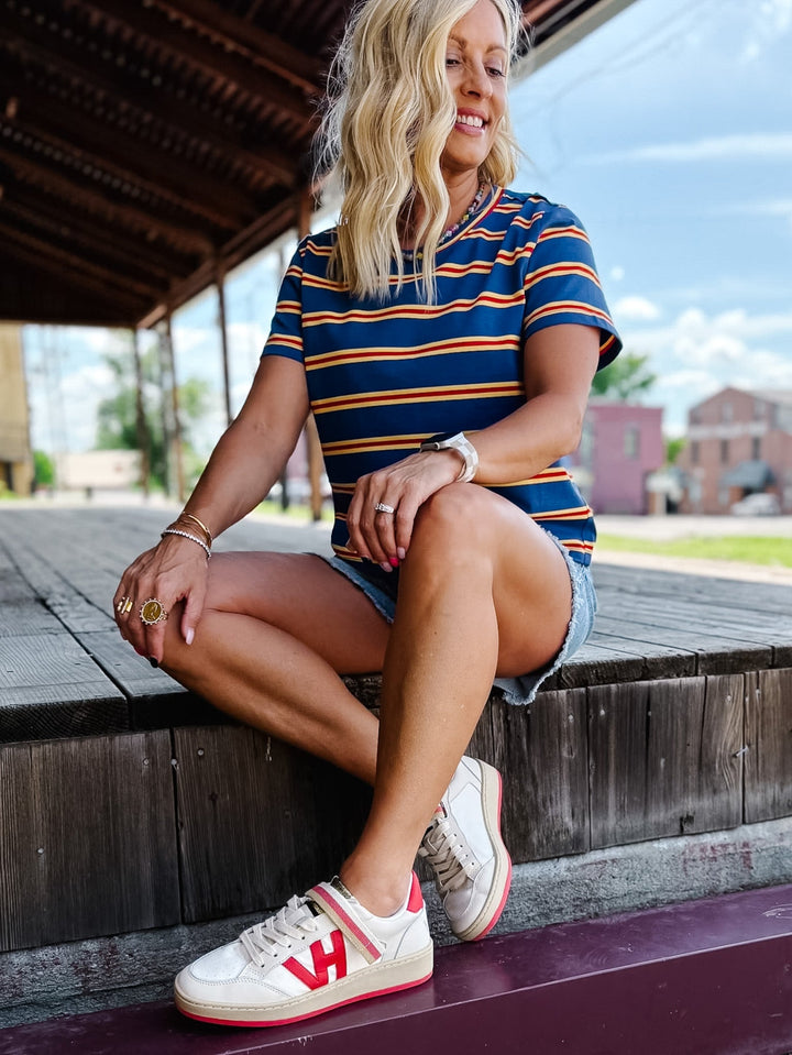 Vintage Havana Next 1 Sneaker with red accents, striped strap, and VH logo.