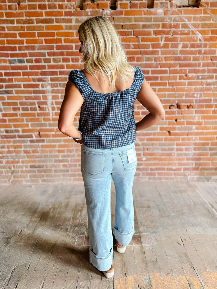 Light wash wide leg jeans with super a high-rise waist and oversized cuffed hems.