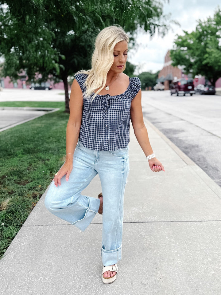 Light wash wide leg jeans with super a high-rise waist and oversized cuffed hems.