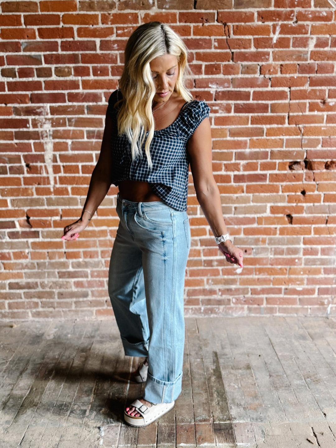 Light wash wide leg jeans with super a high-rise waist and oversized cuffed hems.
