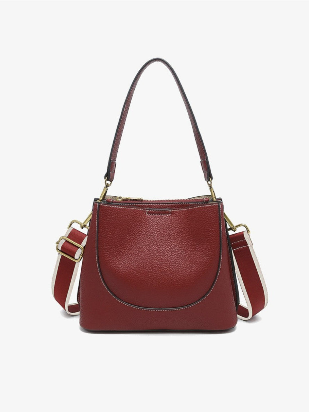 A burgundy pebbled leather handbag with a top handle, a curved front pocket, and a detachable shoulder strap with cream and burgundy sections, shown against a plain white background.