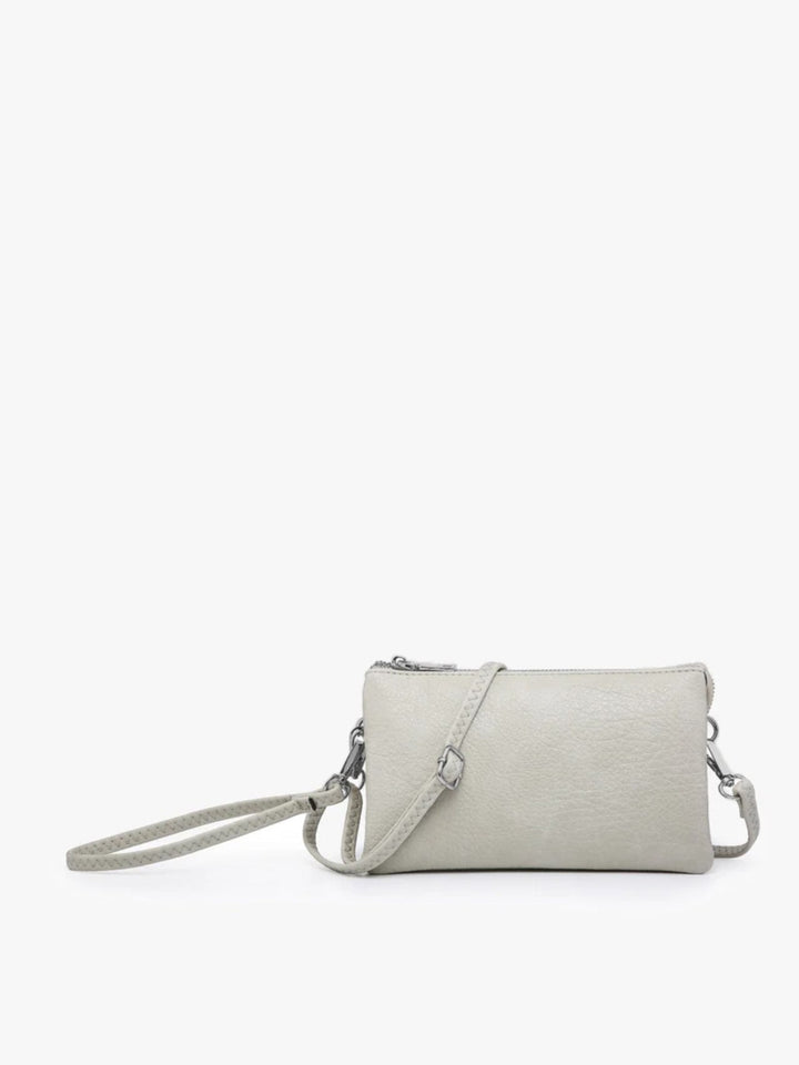 A light gray textured faux-leather crossbody bag with a matching wristlet strap and silver-tone hardware, shown against a plain white background.